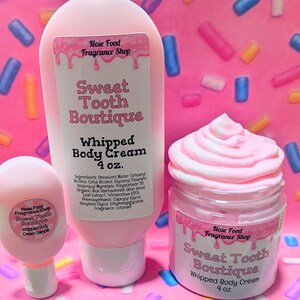 May include: Pink body cream products from Sweet Tooth Boutique. The image shows a small sample, a tube, and a jar of whipped body cream. Each container has a label with the brand name and product information. The background is pink with colorful sprinkles.