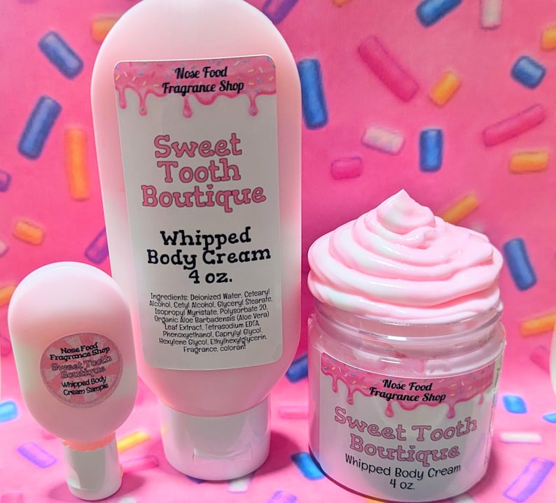 May include: Pink body cream products from Sweet Tooth Boutique. The image shows a small sample, a tube, and a jar of whipped body cream. Each container has a label with the brand name and product information. The background is pink with colorful sprinkles.