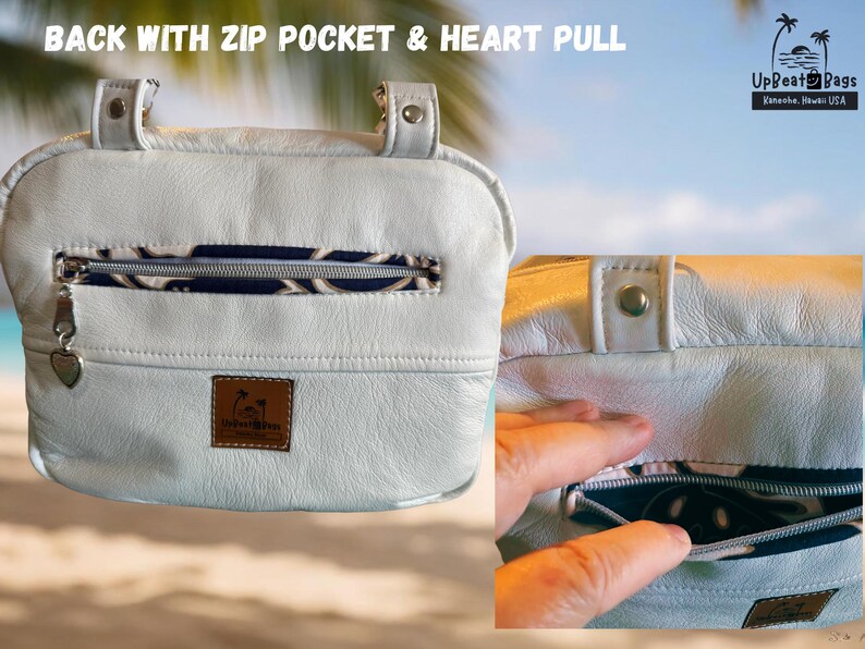 May include: White leather bag with a zip pocket and heart-shaped zipper pull. The bag has a patterned interior and a small logo patch. Text on the image reads "BACK WITH ZIP POCKET & HEART PULL" and "UpBeat Bags, Kaneohe, Hawaii USA."
