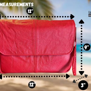 May include: A red leather crossbody bag with a flap closure. The bag is 12 inches wide, 9 inches high, and 3 inches deep. It has a shoulder strap and a small handle. The bag is displayed on a beach background.
