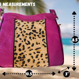 May include: A magenta handbag with a leopard print center panel. The bag measures 10.5 inches wide, 8.5 inches high, and 3 inches deep. The bag has a shoulder strap and gold-colored hardware. The text "BAG MEASUREMENTS" is at the top.