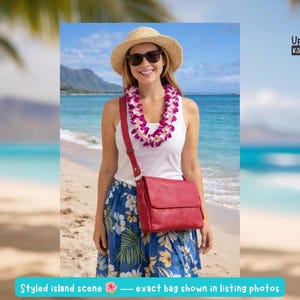 May include: A woman wearing a straw hat, sunglasses, and a lei stands on a beach, holding a red leather crossbody bag. She is wearing a white top and a blue floral skirt. The text "UpBeat Bags Kāne'ohe, Hawaii USA" is visible.