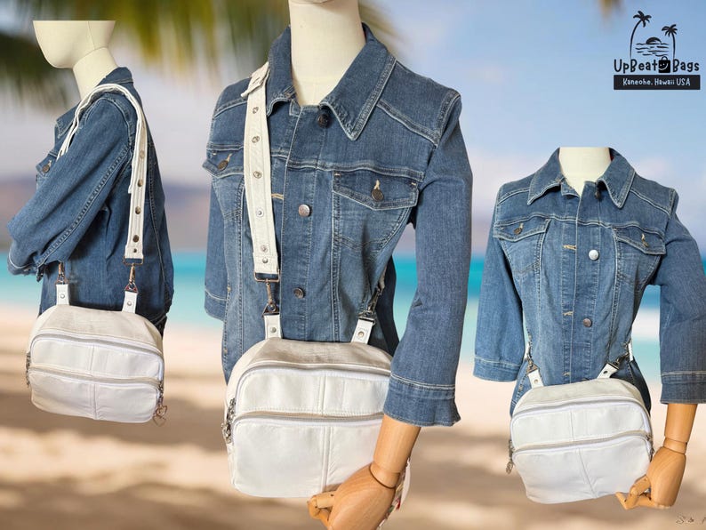 May include: A white leather crossbody bag with a silver zipper and a white adjustable strap. The bag is paired with a denim jacket. The bag has a rectangular shape with a front pocket and a top zipper.