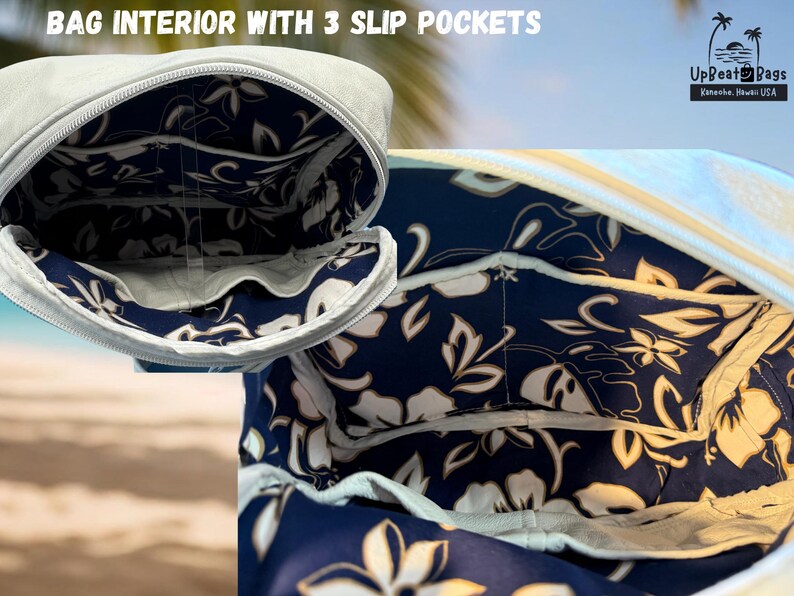 May include: Close-up of a light gray bag interior with three slip pockets. The interior features a navy blue floral pattern with white and cream-colored flowers. The bag has a white zipper and is from UpBeat Bags, Kona, Hawaii, USA.