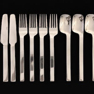 May include: A set of twelve stainless steel flatware pieces arranged in three rows of four, including four knives with straight blades, four four-tined forks, and four spoons with square-shaped bowls and straight, flat handles.
