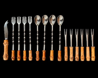 May include: A set of fifteen metal utensils with bamboo handles, including one cheese knife, four two-pronged forks, four spoons, and six two-pronged cocktail picks. Each utensil features a twisted metal stem and a natural bamboo handle.