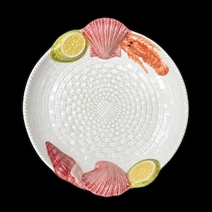 May include: A round white ceramic serving plate with a textured basket-weave pattern. The rim is decorated with three-dimensional painted ceramic accents including two yellow lemon halves, two pink scallop shells, one red lobster, and one red conch shell.