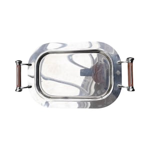 May include: A silver serving tray with two brown wooden handles. The tray is oval shaped and has a raised rim.
