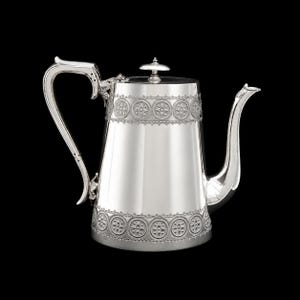May include: A polished silver teapot featuring a tapered cylindrical body with decorative bands of circular floral motifs at the top and bottom. It includes a curved handle with ornate leaf-like attachments, a long spout, and a flat lid with a knob.