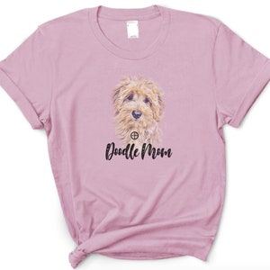May include: A pink t-shirt with a doodle dog graphic and the text "Doodle Mom" printed on the front.