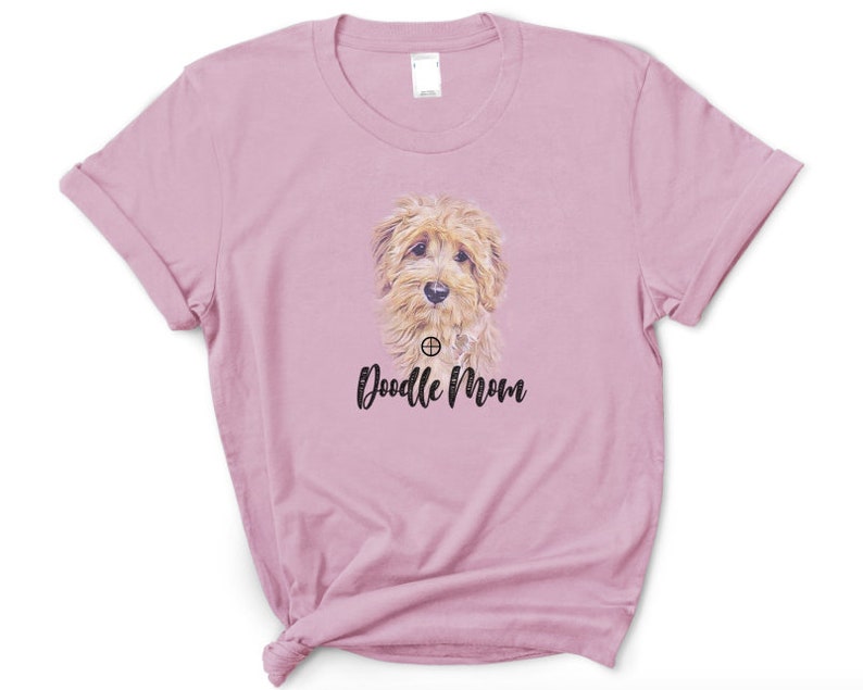 May include: A pink t-shirt with a doodle dog graphic and the text "Doodle Mom" printed on the front.