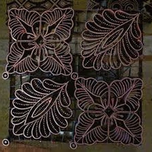 May include: Four batik fabric squares with intricate designs. Two squares feature a floral pattern with a central diamond shape, while the other two squares feature a leaf pattern with a central diamond shape.