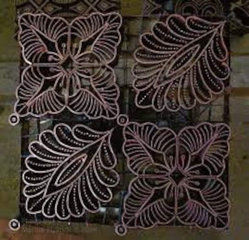 May include: Four batik fabric squares with intricate designs. Two squares feature a floral pattern with a central diamond shape, while the other two squares feature a leaf pattern with a central diamond shape.