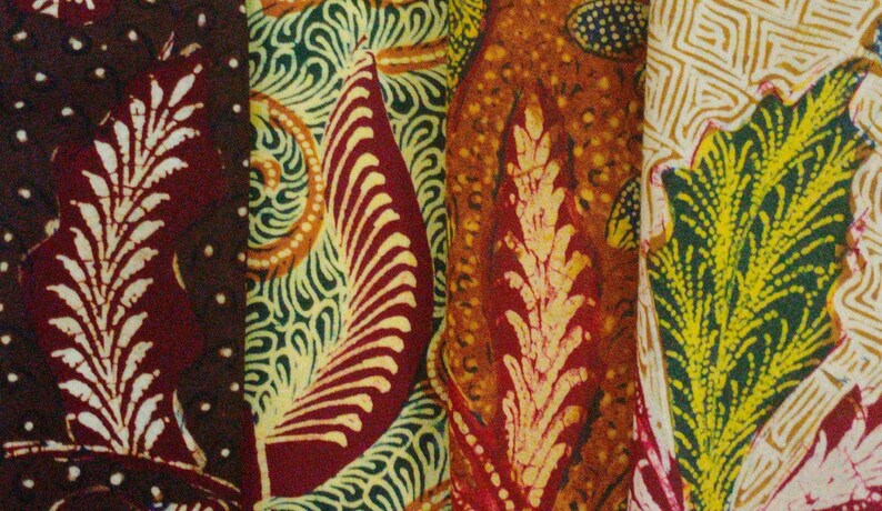 May include: Close-up of four different fabric swatches with intricate patterns. The swatches are in shades of brown, green, orange, and yellow. The patterns are floral and geometric.