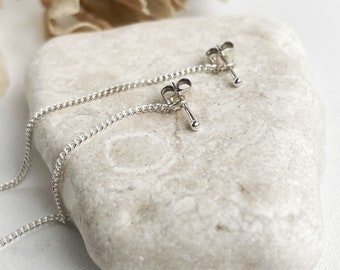 Handmade sterling silver elegant stud earrings with a chain, minimalist style.