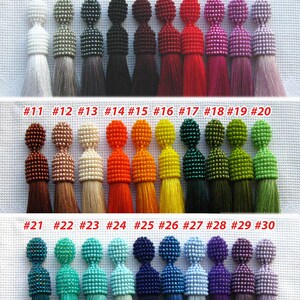 May include: Thirty beaded tassel earrings in various colors, including white, gray, black, red, pink, orange, yellow, green, blue, and purple. The earrings are numbered 1 through 30.