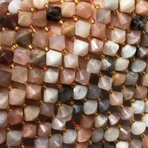 Puede incluir: Una hebra de cuentas de piedras preciosas de varios colores y formas, incluyendo blanco, rosa y marrón. Las cuentas son facetadas y tienen un acabado brillante e iridiscente.