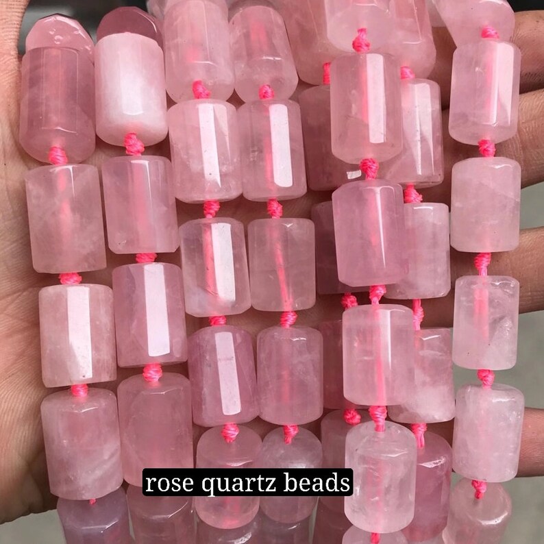 May include: A strand of pink rose quartz beads, each bead is a smooth, faceted cylinder, strung together with pink thread. The beads are arranged in rows, creating a visually appealing pattern.  "rose quartz beads" is written in white text at the bottom of the image.