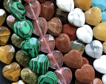 May include: A variety of heart-shaped gemstone beads in various colors, including green, brown, pink, white, and yellow. The beads are strung together on a clear string.