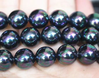 May include: A strand of iridescent black pearls. The pearls are round and have a smooth, glossy finish.