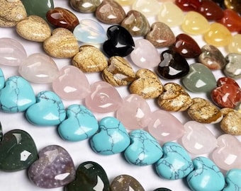 May include: A collection of heart-shaped gemstone beads in various colors, including turquoise, pink, brown, and black. The beads are arranged in rows, showcasing their different textures and hues. Ideal for jewelry making.