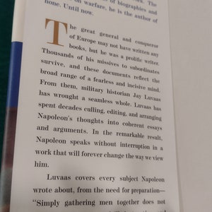 May include: A book cover with a white background and black text. The title of the book is "Napoleon" and the text describes Napoleon as a great general and conqueror of Europe. The text also mentions that Napoleon was a prolific writer and that the book is a collection of his writings.