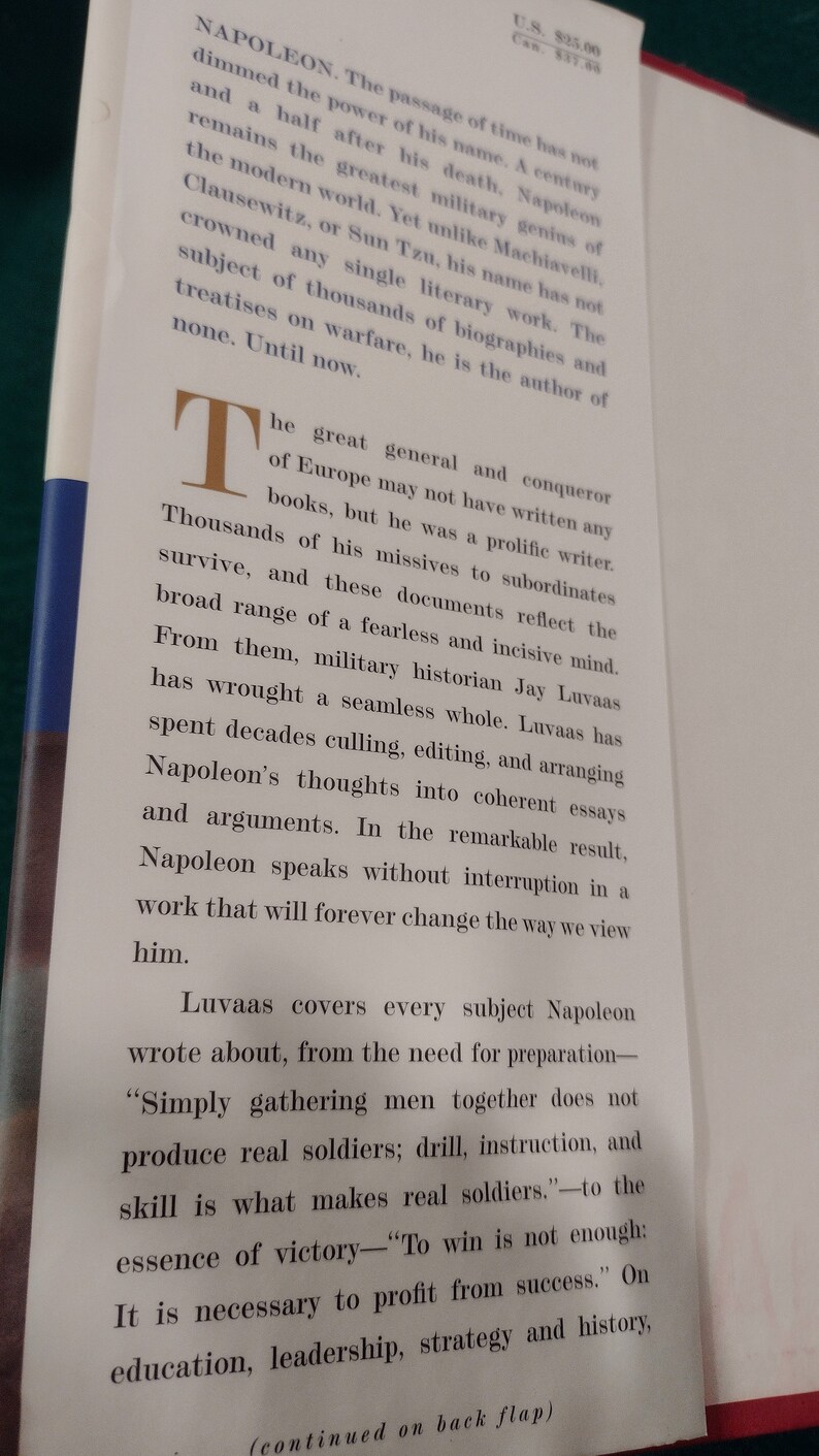 May include: A book cover with a white background and black text. The title of the book is "Napoleon" and the text describes Napoleon as a great general and conqueror of Europe. The text also mentions that Napoleon was a prolific writer and that the book is a collection of his writings.