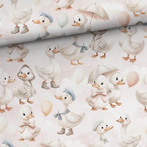 May include: A repeating pattern of white ducks with orange beaks and feet, wearing hats, raincoats, and bows. Some ducks hold umbrellas or balloons. The background is a soft pink with white cloud shapes.