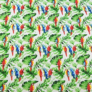 May include: A white fabric with a repeating pattern of colorful parrots perched on green tropical leaves. The parrots are red, blue, and yellow.