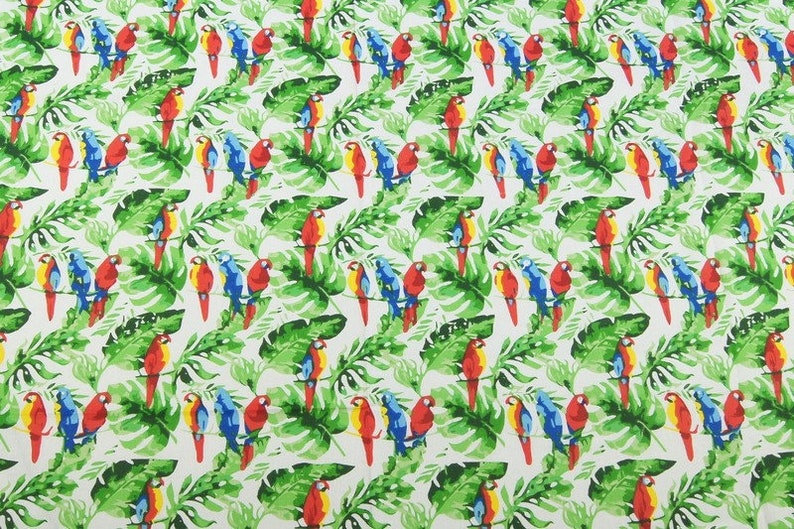 May include: A white fabric with a repeating pattern of colorful parrots perched on green tropical leaves. The parrots are red, blue, and yellow.