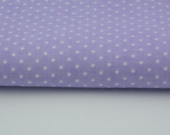 Puede incluir: Un primer plano de una tela morada con lunares blancos. La tela está doblada por la mitad y los lunares blancos son visibles en ambos lados del pliegue.