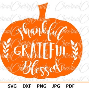 May include: Orange pumpkin silhouette with the text "Thankful Grateful Blessed" in white lettering. The pumpkin has a stem and leaves on either side of the text.