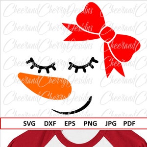 May include: A white t-shirt with a red bow and a snowman face with closed eyes, an orange nose, and a black smile. The shirt has red sleeves.