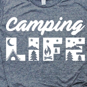 May include: A heather gray t-shirt with the words "Camping LIFE" in white. The word "LIFE" features camping-themed illustrations, including a tent, moon, mountains, stars, a campfire, and trees.