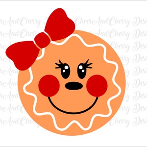 May include: A gingerbread cookie with a smiling face, red cheeks, and a red bow on top. The cookie is decorated with white icing.