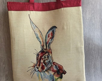 Stunning tapestry hare tote bag with raspberry coloured lining, double slip pocket and zipped pocket.