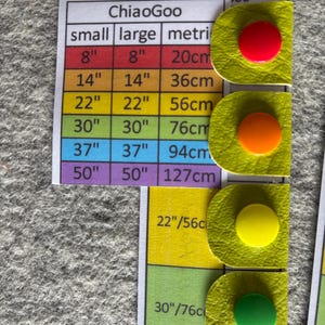 A laminated reference card shows measurements of cable length for interchangeable needle cables. They correspond to Chicago cables and have a different colour for each size. The vinyl snap tabs have corresponding snap tab colours to match the cable length.