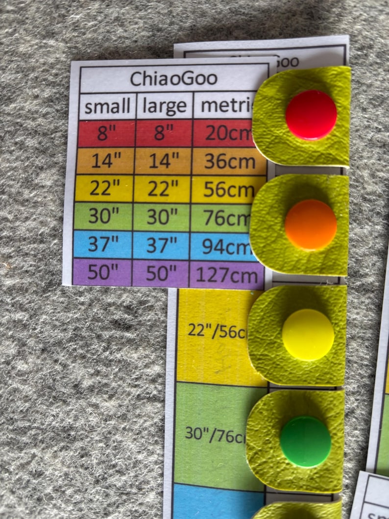 A laminated reference card shows measurements of cable length for interchangeable needle cables. They correspond to Chicago cables and have a different colour for each size. The vinyl snap tabs have corresponding snap tab colours to match the cable length.
