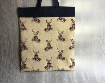 Stunning tapestry hare tote bag with denim contrast band and handles, slip pocket and zipped pocket inside.
