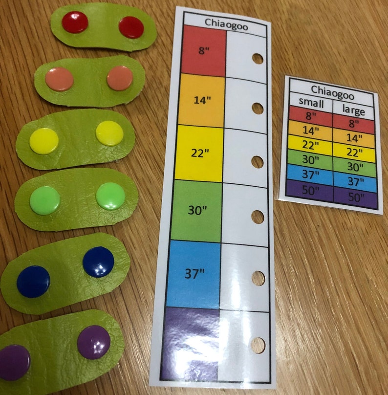 May include: A set of colorful circular buttons in various sizes, arranged in rows on green oval-shaped pieces of fabric. A chart with the text "Chiaogoo" and measurements in inches is shown on the right side of the image.