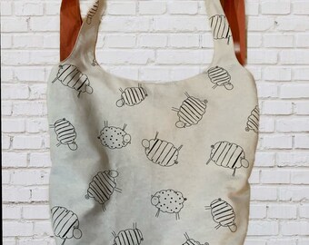 Canvas convertible shoulder bag or backpack. Sheep print tote bag with zip pocket.