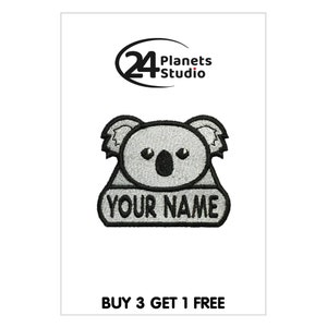 May include: Embroidered iron-on patch featuring a gray koala with black eyes and nose. The koala is holding a banner that says "YOUR NAME".