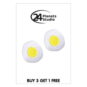 May include: Two white embroidered iron-on patches shaped like fried eggs with yellow yolks. The patches are on a white background. The text "BUY 3 GET 1 FREE" is at the bottom of the image.