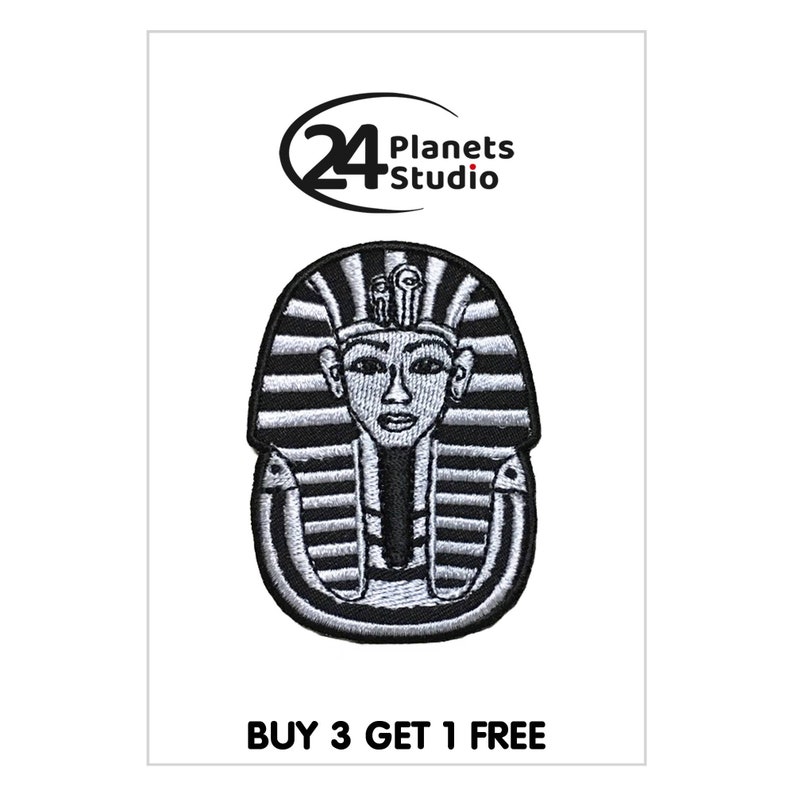 May include: Black and white embroidered iron-on patch of an Egyptian pharaoh's head with a headdress. The patch is surrounded by a black outline. The text "24 Planets Studio" is in the top left corner of the image. The text "BUY 3 GET 1 FREE" is at the bottom of the image.