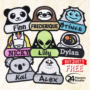 May include: Eight colorful iron-on patches featuring various animal and cartoon characters with names printed below each. The patches include a panda, sloth, yeti, unicorn, alien, astronaut, koala, and seal. The text "BUY 3 GET 1 FREE" is printed in red and white on a white background. The text "24 Planets Studio" is printed in black and white on a white background.