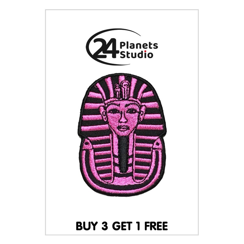 May include: Pink embroidered iron-on patch of an Egyptian pharaoh's head with a black outline. The patch features the text "24 Planets Studio" and "BUY 3 GET 1 FREE".