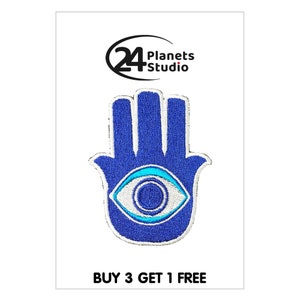 May include: Blue embroidered patch featuring a hamsa hand design with a blue evil eye in the centre. The patch has white stitching around the edges and the text "BUY 3 GET 1 FREE" at the bottom.