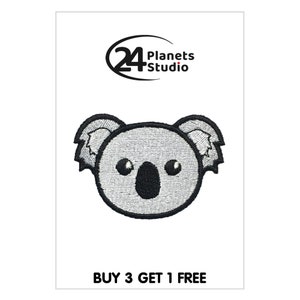 May include: Embroidered iron-on patch featuring a cute cartoon koala bear with black eyes and a black nose. The koala is gray and white with black outlines. The patch is surrounded by a white background. The text "BUY 3 GET 1 FREE" is printed below the patch.