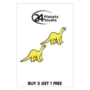 May include: Two yellow embroidered iron-on patches of dinosaurs. The patches are on a white background. The text "BUY 3 GET 1 FREE" is at the bottom of the image.
