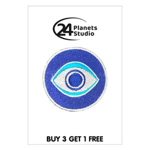 May include: Blue and white embroidered eye patch with a turquoise outline. The patch is circular and has the text "24 Planets Studio" above it and "BUY 3 GET 1 FREE" below it.
